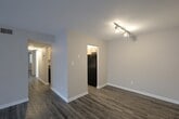 This contemporary 880 square foot residence in New Bern, NC offers a well-designed living space with three bedrooms and three full bathrooms. The single-story layout promotes easy accessibility throughout. The home showcases a blend of modern finishes, including sleek gray wood-look flooring in the main living areas and plush carpeting in the bedrooms.

The living room is spacious and bright, with recessed lighting and a neutral color scheme that creates a versatile backdrop for various decor styles. The kitchen features light wood cabinetry, contrasting dark countertops, and black appliances, including a modern range. 

Bathrooms are equipped with essential fixtures, including pedestal sinks and shower-tub combinations. The primary bedroom, measuring 140 square feet, provides a cozy retreat. Large windows in the bedrooms allow natural light to flood the spaces, while vertical blinds in some areas offer light control and privacy.

Storage solutions are integrated throughout, with closets featuring louvered doors. The home's neutral palette and contemporary fixtures create a clean, fresh ambiance, making it an ideal canvas for personalization. The overall design emphasizes functionality and modern comfort in a compact yet efficient floor plan.