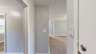 Located at 8402 Greenway Rd in Towson, MD, this single-floor, 4-bedroom, 1-bathroom home offers a practical and well-organized layout. The interior is finished with neutral gray walls and wall-to-wall carpeting throughout the bedrooms, creating a consistent and cohesive aesthetic.

The primary bedroom is generously sized, featuring a wide triple-pane window that fills the room with natural light and views of the surrounding neighborhood. It is complemented by a closet and easy access to the rest of the home. The three additional bedrooms are each well-proportioned, with individual windows that allow ample daylight; several offer views of mature trees, adding a touch of greenery to the interiors.

The kitchen is equipped with warm oak cabinetry spanning both upper and lower sections, dark countertops, a stainless steel sink, and black appliances including a gas range and refrigerator. Wood-look flooring in the kitchen provides a practical contrast to the carpeted living areas.

The bathroom is cleanly appointed with a tiled shower-tub combination, wood-look flooring, a granite-topped vanity, and a window that brings in natural light. White trim and paneled doors are consistent features throughout the home, contributing to its tidy, functional character.