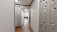 Located at 4000 Sigma Rd in Farmers Branch, TX, this 2-bedroom, 2-bathroom residence offers a thoughtfully designed single-story layout with a clean, contemporary aesthetic throughout. A welcoming hallway with wood-look flooring and crown molding leads into the main living areas, setting a polished tone from the moment you enter.

The open living and dining area is bright and inviting, with a sliding glass door that fills the space with natural light and provides outdoor access. The kitchen features dark espresso cabinetry, granite-style countertops, and wood-look flooring, with a window that brings in additional natural light. The adjacent dining area is well-proportioned and connects seamlessly to the living space.

Both bedrooms are carpeted for comfort and equipped with ceiling fans. The spacious primary bedroom includes a closet and ample room to furnish comfortably. The second bedroom is similarly appointed, with direct sightlines to the kitchen and easy access to the hallway.

The two bathrooms are finished with light tile flooring and dark wood vanities with white countertops. One bathroom features a glass-enclosed walk-in shower, while the second offers a shower-tub combination. Together, they deliver a clean, functional design that complements the overall character of this well-maintained residence.