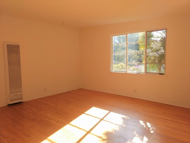 Front room with wall heater - 715 Pacific St