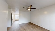 Located at 11501 Harts Rd in Jacksonville, FL, this single-story, 3-bedroom, 2-bathroom home offers a functional and well-organized layout. Wood-look flooring flows consistently throughout the entire home, providing a cohesive and low-maintenance finish. The living room is a comfortable gathering space featuring a ceiling fan with light kit and a large window that allows natural light to fill the room. The kitchen and dining area are combined into one practical space, equipped with white cabinetry, dark countertops, black appliances including a refrigerator, range, and dishwasher, and a sink positioned beneath upper cabinets. A pantry offers additional storage adjacent to the kitchen. The three bedrooms are well-proportioned, each featuring wood-look flooring, and several include closets — with one bedroom showcasing a built-in shelved closet. Ceiling fans are present in multiple rooms for added comfort. The two bathrooms are each outfitted with a tub-shower combo, and one features a dark-countered vanity with a mirror. A dedicated laundry room and four closets throughout the home ensure ample storage. The textured ceilings are consistent across the home, adding a classic touch to the clean, neutral interior palette.