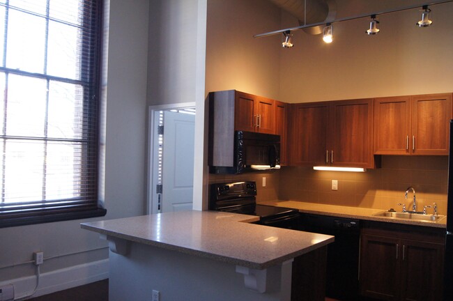 Kitchen with an island - Residences at South High