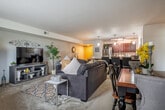 Located at 825 Jupiter Dr in Madison, Wisconsin, this single-floor, 2-bedroom, 2-bathroom residence offers a well-designed layout with generous living space. The open-concept living and dining area flows seamlessly into the kitchen, creating an inviting and functional gathering space. The living room features plush carpeting, ample room for comfortable seating arrangements, and a neutral color palette that lends a warm, cohesive feel throughout.

The kitchen is outfitted with rich dark wood cabinetry, stainless steel appliances including a refrigerator, range, and microwave, and a large granite-topped island with bar seating. Hardwood-style flooring, pendant lighting, and generous counter space make this kitchen as practical as it is attractive.

The primary bedroom is a spacious retreat, complete with a ceiling fan, natural light from a window with curtains, and direct access to an en-suite bathroom. The second bedroom is versatile, featuring a window with outdoor views and a closet, suitable as a guest room or home office. Both bathrooms are clean and functional, with one featuring a full tub-shower combination.

Additional highlights include four closets for abundant storage, an in-unit laundry area, a hallway connecting the living spaces, and a private patio perfect for outdoor relaxation.