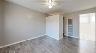 Located at 3734 W El Segundo Blvd in Hawthorne, CA, this efficiently designed one-bedroom, one-bathroom unit offers a comfortable and functional layout across a single floor. Warm honey-toned hardwood flooring runs throughout the living spaces, lending a clean and inviting aesthetic to every room.

The living room is bright and open, featuring a ceiling fan, neutral gray walls with crisp white baseboards, and a large window dressed with vertical blinds that allow natural light to filter in while offering a view of the greenery outside. A warm-toned entry door adds a welcoming touch.

The bedroom is a well-proportioned private retreat, also finished with the same hardwood flooring and ceiling fan. A horizontal window near the top of the wall brings in natural light and outdoor views, maintaining a sense of openness. Two closets provide practical storage throughout the unit.

The kitchen is compact and efficiently arranged, equipped with a gas stovetop and ample counter space. The bathroom is clean and bright, featuring all-white tile walls, a full bathtub with a shower combo, chrome fixtures, and a small window that introduces natural ventilation and light. The overall ambiance of the unit is clean, neutral, and move-in ready, making it a practical option in the Hawthorne area.