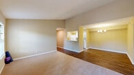 Located in Tallahassee, FL, this well-appointed single-story, one-bedroom, one-bathroom home offers a thoughtful layout with a warm, inviting ambiance throughout. Neutral warm-toned walls and a mix of hardwood-style flooring and plush carpeting create a cohesive aesthetic across the living spaces.

The living room is a standout feature, offering a cozy fireplace with a white mantel, multiple windows that invite natural light, and direct access to a private outdoor patio. Adjacent to the living room, the dining area is defined by vaulted ceilings and an elegant chandelier, adding a sense of height and openness to the space.

The galley-style kitchen is efficiently designed with white cabinetry, a subway tile backsplash, light countertops, a double sink, and white appliances including a refrigerator, dishwasher, and range. A pass-through connects the kitchen to the main living area.

The spacious bedroom features plush carpeting, a ceiling fan with light fixture, and generous closet access. The bathroom includes a vanity with light countertops, a large mirror, and a shower/tub combination. A dedicated laundry area and four closets throughout the home provide exceptional storage. The entrance and dual hallways ensure smooth flow between all areas.