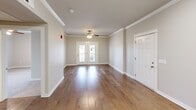 Located at 3009 N Arden Way in Siloam Springs, AR, this 2-bedroom, 1-bathroom unit offers a well-designed single-floor layout that makes efficient use of its space. The open-concept living area greets you with rich hardwood flooring, crown molding, a ceiling fan, and French doors that allow natural light to flow in and provide access to an outdoor balcony area.

The kitchen is a standout feature, outfitted with white shaker-style cabinetry, granite countertops, a peninsula with bar seating, tile flooring, and a full suite of stainless steel appliances including a refrigerator, electric range, and microwave. Recessed lighting and crown molding add a polished finish to the space.

Both bedrooms are carpeted and finished with neutral-toned walls, offering a calm and comfortable retreat. The spacious primary bedroom includes a window with outdoor views of the surrounding community. The second bedroom is equally well-proportioned with ample wall space.

The bathroom is clean and functional, featuring tile flooring, a granite-topped vanity with white cabinetry, brushed nickel hardware, and a full tub/shower combination. A hallway connects the rooms with ease, and a utility panel is conveniently accessible in the main living area.