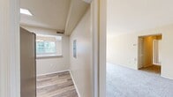 This Newport Village apartment, identified as Two Bedroom B1B 48-45030, is a well-appointed 960 square foot living space spread across a single floor. The unit comprises two bedrooms, with the primary bedroom boasting a generous 200 square feet. The layout includes a single bathroom, living room, kitchen, laundry area, entrance, hallway, and closet space.

The interior exudes a clean, contemporary aesthetic with neutral-toned walls and plush carpeting in the bedrooms and living areas. Large windows in the bedrooms and living room invite ample natural light, creating a bright and airy atmosphere. The living room offers a spacious area for relaxation and entertainment, with sliding glass doors leading to an outdoor space.

The kitchen showcases a modern design with a mix of white upper cabinets and wood-grain lower cabinets, complemented by sleek stainless steel appliances and a subway tile backsplash. The bathroom features a white suite with a shower-tub combination and ample counter space.

A dedicated laundry room with full-sized washer and dryer adds convenience to daily living. The apartment's thoughtful design maximizes space utilization, evident in the 3D floor plan, which reveals a well-organized and flowing layout. Overall, this Newport Village apartment offers a comfortable and stylish living environment with modern amenities and a practical design.