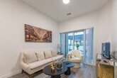 Located at 375 South Street in London, Ontario, this thoughtfully designed unit offers a functional and modern single-floor layout. The open-concept living and dining area serves as the heart of the space, featuring light hardwood-style flooring, recessed lighting, and high ceilings that lend an airy, spacious feel. A set of sliding glass doors connects the living area to a private balcony, allowing natural light to pour in and offering outdoor access.

The galley-style kitchen is efficiently organized with floor-to-ceiling white cabinetry, grey quartz-style countertops, a stainless steel sink, and a full suite of stainless steel appliances including a range, dishwasher, and refrigerator. A white subway tile backsplash adds a clean, contemporary finish.

Two well-proportioned bedrooms each feature sliding-door closets and the same warm hardwood-style flooring found throughout the unit. The rooms are bright and neutral, providing a calm and restful atmosphere. The full bathroom is finished with grey tile flooring, a combined tub and shower, a vanity with matching countertops, and clean white wall tile, completing the cohesive modern aesthetic found throughout this well-appointed home.