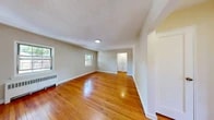 Located at 86 Warren Street, Unit 3A in Nutley, NJ, this one-bedroom, one-bathroom residence offers a well-organized layout across a single floor. Warm-toned hardwood floors flow throughout the main living areas, reflecting natural light and lending the space a bright, inviting character.

The living room is generously sized, framed by multiple windows that allow ample natural light to fill the room. A radiator unit provides classic in-unit heating. The space connects seamlessly to a separate dining room, offering a defined area for meals and entertaining. The kitchen is equipped with white shaker-style cabinetry, granite countertops, a stainless steel sink, and a painted brick backsplash, creating a clean and functional cooking environment with light wood-style flooring.

The bedroom is a comfortable, well-proportioned retreat with hardwood floors, neutral walls, and a closet. The unit features an impressive five closets throughout, providing exceptional storage. The bathroom is finished with white tile surround, a tub-shower combination, a white vanity with cabinet storage, and a medicine cabinet mirror. A hallway connects the rooms efficiently, completing this practical and well-maintained residence in a convenient New Jersey location.