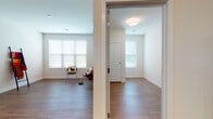 Located at 2001 Traceway Dr in Fitchburg, Wisconsin, this single-floor unit offers a well-designed layout that balances functionality with modern finishes. The open living and dining area is anchored by warm hardwood-style flooring and multiple windows that allow generous natural light to fill the space, creating a bright and welcoming atmosphere throughout.

The kitchen is a standout feature, outfitted with rich dark-stained cabinetry, granite countertops, and a full suite of stainless steel appliances including a refrigerator, dishwasher, microwave, and range. Ample upper and lower cabinet storage makes this kitchen as practical as it is visually appealing.

The bedroom areas include both hardwood-style flooring and carpeted options, each with windows overlooking the outdoors and generous closet access. The bathroom is thoughtfully designed with accessibility in mind, featuring grab bars in the walk-in shower, a dark wood vanity with granite countertop, a large mirror, and hardwood-style flooring.

Throughout the unit, clean white walls, wide baseboards, and recessed and overhead lighting contribute to a crisp, contemporary aesthetic. The layout flows naturally between rooms, offering a comfortable and efficient living environment suited for everyday life.