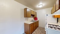 This single-floor unit at 323 Manzana Ct NW in Walker, Michigan offers a straightforward, functional layout designed for practical everyday living. The kitchen is equipped with warm oak-toned cabinetry spanning both upper and lower sections, a double-basin sink, a gas range with overhead ventilation, and a full-size refrigerator. Tile-style flooring runs throughout the kitchen, providing durability and easy maintenance.

The living area is generously proportioned, featuring plush wall-to-wall carpeting and neutral-toned walls that create a clean, adaptable backdrop. A sliding glass door floods the space with natural light and provides direct views of the surrounding outdoor environment, with vertical blinds offering privacy control. A wall-mounted air conditioning unit serves the living area.

The bedroom is carpeted and well-sized, featuring a built-in closet with bifold doors offering organized storage with shelving and a hanging rod. A window brings in natural light and views of the surrounding greenery.

The bathroom includes a single-sink vanity with a large mirror, tile-style flooring, and a full tub-shower combination, maintaining a clean and utilitarian design throughout. Overall, the unit presents a practical and comfortable living environment in a quiet Walker, Michigan location.