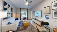 Located at 16101 Murphy Ave in Irvine, CA, this well-designed 2-bedroom, 2-bathroom residence offers a thoughtful layout across a single floor. The open-concept kitchen and living area serves as the heart of the home, featuring white shaker cabinetry, stainless steel appliances including a gas range and French door refrigerator, a large quartz island with pendant lighting and bar seating, and light hardwood-style flooring that flows throughout the main living areas. The living room is bright and inviting, with access to an outdoor area and wall space ideal for entertaining. The spacious primary bedroom offers tall ceilings, plush carpeting, and a serene neutral palette, while the second bedroom features a ceiling fan, a bold accent wall, and a large window that fills the room with natural light. The two bathrooms are clean and modern — one featuring a walk-in tile shower with built-in shelving, and the other a soaking tub with subway tile surround. A dedicated hallway connects the rooms seamlessly, and a closet provides additional storage. The overall ambiance is contemporary and cohesive, with neutral tones, recessed lighting, and modern finishes throughout.
