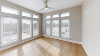 Located at 222 S Main St in Mooresville, NC, this well-appointed single-story home offers three bedrooms, two bathrooms, and a thoughtfully designed layout. Light wood-tone flooring runs consistently throughout, creating a warm, cohesive aesthetic. The open kitchen and living area serves as the heart of the home, featuring white shaker-style cabinetry, warm wood lower cabinets, stainless steel appliances, a peninsula with a undermount sink, quartz countertops, and pendant lighting. The living area is flooded with natural light through an impressive bank of floor-to-ceiling windows with transom panels above, complemented by a ceiling fan. The primary bedroom is generously sized, while the two additional bedrooms offer clean, neutral spaces with light-toned walls and wood flooring. The primary bathroom includes a walk-in glass shower, a double-sink vanity with wood cabinetry and white countertops, and recessed lighting. The second bathroom features a tiled soaking tub and shower combination with a window for natural light. The home also includes two hallways, a dedicated entrance, and a closet, maximizing functionality and flow throughout.