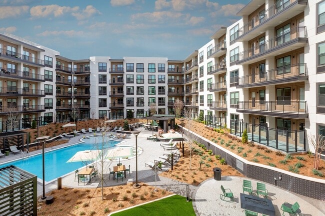 Resort-style Swimming Pool with Tanning Ledge Cabanas and Sundeck - Bexley Chamblee