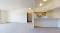 Located at 15408 E Fourth Ave in Spokane Valley, Washington, this single-floor unit offers a functional and well-organized layout designed for comfortable everyday living. The open-concept living and dining area is finished with neutral wall-to-wall carpeting and features a sliding glass door that opens to a balcony, allowing natural light to fill the space. A wall-mounted air conditioning unit provides additional climate control in the living area, complemented by baseboard heating throughout.

The kitchen is positioned adjacent to the living space and is equipped with light wood cabinetry, a tile backsplash, white appliances including a refrigerator, electric range, built-in microwave, and dishwasher, along with ample counter space and a double-basin sink. A breakfast bar creates a convenient pass-through between the kitchen and living area.

The unit includes two generously sized bedrooms, each carpeted and featuring windows that bring in natural light and neighborhood views, along with baseboard heating. Both full bathrooms are appointed with a tub/shower combination, a single-sink vanity with light wood cabinetry, a large mirror, and tile flooring.

A dedicated laundry closet houses a full-size top-loading washer and dryer, adding everyday convenience to this well-appointed Spokane Valley residence.