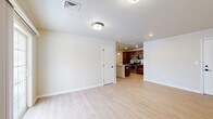 Located at 211 Sacandaga Rd in Schenectady, NY, this single-floor, three-bedroom, two-bathroom home offers a well-designed layout with a clean, modern aesthetic. The open-concept living and kitchen area serves as the heart of the home, where light hardwood-style flooring flows seamlessly throughout. The kitchen is a standout feature, appointed with rich dark wood cabinetry, granite countertops, a peninsula with a built-in sink, pendant lighting, and a full suite of stainless steel appliances including a refrigerator, range, and over-the-range microwave. The living area is bright and open, with a sliding glass door that invites natural light. The primary bedroom is generously sized and features plush carpeting, neutral tones, and direct access to a private bathroom. The two additional bedrooms also feature soft carpet and ample natural light from large windows. The bathrooms are finished with tile flooring and include a clean, walk-in shower stall. A dedicated utility room adds functional storage and mechanical space. Throughout the home, crisp white trim, neutral wall tones, and consistent finishes create a cohesive and move-in-ready environment.