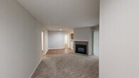 Located at 7303 Bryn Athyn Way in Raleigh, NC, this two-bedroom, two-bathroom residence offers a well-organized single-floor layout with a cohesive neutral palette throughout. The living room serves as the heart of the home, featuring plush carpeting, a tile-surround fireplace, and a textured ceiling that adds subtle character to the space. A connected hallway with hardwood-style flooring guides residents through the layout seamlessly.

The kitchen is efficiently designed with warm wood cabinetry, dark countertops, and stainless steel appliances including a refrigerator and dishwasher. A window above the sink brings in natural light, making the space feel bright and functional.

Both bedrooms are carpeted and equipped with ceiling fans for year-round comfort. The primary bedroom offers a generous footprint with a dedicated walk-in closet featuring built-in shelving and hanging rods. The second bedroom also benefits from a ceiling fan and convenient closet access.

The two bathrooms each include a full tub-shower combination. One bathroom features warm wood vanity cabinetry with a single-basin sink and a large mirror with overhead lighting, while the second offers a clean, straightforward layout. Hardwood-style flooring in the bathrooms adds a cohesive touch. A hallway ties all rooms together, completing this practical and comfortable residential layout.