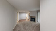 Located at 7303 Bryn Athyn Way in Raleigh, NC, this two-bedroom, two-bathroom residence offers a well-organized single-floor layout with a cohesive neutral palette throughout. The living room serves as the heart of the home, featuring plush carpeting, a tile-surround fireplace, and a textured ceiling that adds subtle character to the space. A connected hallway with hardwood-style flooring guides residents through the layout seamlessly.

The kitchen is efficiently designed with warm wood cabinetry, dark countertops, and stainless steel appliances including a refrigerator and dishwasher. A window above the sink brings in natural light, making the space feel bright and functional.

Both bedrooms are carpeted and equipped with ceiling fans for year-round comfort. The primary bedroom offers a generous footprint with a dedicated walk-in closet featuring built-in shelving and hanging rods. The second bedroom also benefits from a ceiling fan and convenient closet access.

The two bathrooms each include a full tub-shower combination. One bathroom features warm wood vanity cabinetry with a single-basin sink and a large mirror with overhead lighting, while the second offers a clean, straightforward layout. Hardwood-style flooring in the bathrooms adds a cohesive touch. A hallway ties all rooms together, completing this practical and comfortable residential layout.