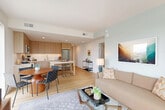 Located at 420 Mendocino Ave in Santa Rosa, CA, this well-appointed 2-bedroom, 2-bathroom residence offers a thoughtfully designed single-floor layout with a clean, contemporary aesthetic throughout. Light hardwood flooring flows seamlessly from the welcoming hallway into the open-concept living, dining, and kitchen area, which serves as the heart of the home. The kitchen is outfitted with flat-front light wood cabinetry extending to the ceiling, white tile backsplash, stainless steel appliances, a gas range, and a central island with bar seating — ideal for both everyday cooking and entertaining. The dining area comfortably accommodates a full table, while the living room benefits from large picture windows that invite abundant natural light and offer open views of the surrounding Santa Rosa cityscape. The primary bedroom is a comfortable retreat with light-filled windows, hardwood floors, and direct access to a private bathroom. The second bedroom is equally well-sized with its own closet. Both bathrooms feature modern wood vanities and clean white tile, with one including a full soaking tub and glass enclosure. A dedicated laundry area and two closets add practical storage. The hallway entry, accented with recessed lighting and a ceiling vent system, connects all spaces efficiently, completing this polished urban residence.