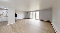 Located at 23462 Lorain Rd in North Olmsted, Ohio, this 2-bedroom, 1-bathroom unit offers a practical and well-organized single-floor layout. The open living room is a standout space, featuring light wood laminate flooring, neutral gray walls, baseboard heating, and a large sliding glass door that floods the room with natural light and provides access to a balcony overlooking a tree-lined neighborhood streetscape.

The kitchen is thoughtfully updated with white shaker-style cabinetry, warm butcher block countertops, a Whirlpool electric range, a full-size refrigerator, and open wood shelving — combining function with character.

Both bedrooms are carpeted and finished with the same neutral palette, offering a calm and comfortable atmosphere. Each room features windows that bring in natural light and views of the surrounding greenery. The primary bedroom is generously sized and includes access to multiple closets. The full bathroom is clean and classic, with white tile surrounding the shower-tub combination, a vanity, and wood-look flooring.

A connecting hallway ties the layout together efficiently. Baseboard heating is present throughout. The balcony provides a pleasant outdoor extension with ornamental iron railings and views of mature trees and landscaping.