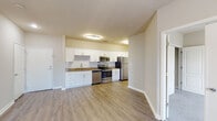 Located at 59 Anderson Ave in Canton, Georgia, this single-floor residence offers a well-designed, open-concept layout with clean, modern finishes throughout. The kitchen serves as a functional centerpiece, outfitted with white shaker-style cabinetry, granite-look countertops, a subway tile backsplash, and a full suite of stainless steel appliances including a refrigerator, electric range, microwave, and dishwasher. Wood-look luxury vinyl plank flooring runs through the main living and kitchen areas, providing a cohesive and durable surface underfoot. The open living area is bright and versatile, with ceiling fans providing additional comfort and windows fitted with blinds that allow natural light to filter in. The bedrooms feature plush wall-to-wall carpeting, ceiling fans, and generously sized windows that bring in natural light. Each bedroom also includes closet access via classic arched-panel doors. The bathroom is appointed with a wide vanity featuring white cabinetry, granite-look countertops, a large framed mirror, and wood-look flooring that ties into the overall aesthetic of the residence. The neutral color palette and consistent finishes throughout create a clean, inviting atmosphere well-suited to a variety of living arrangements.