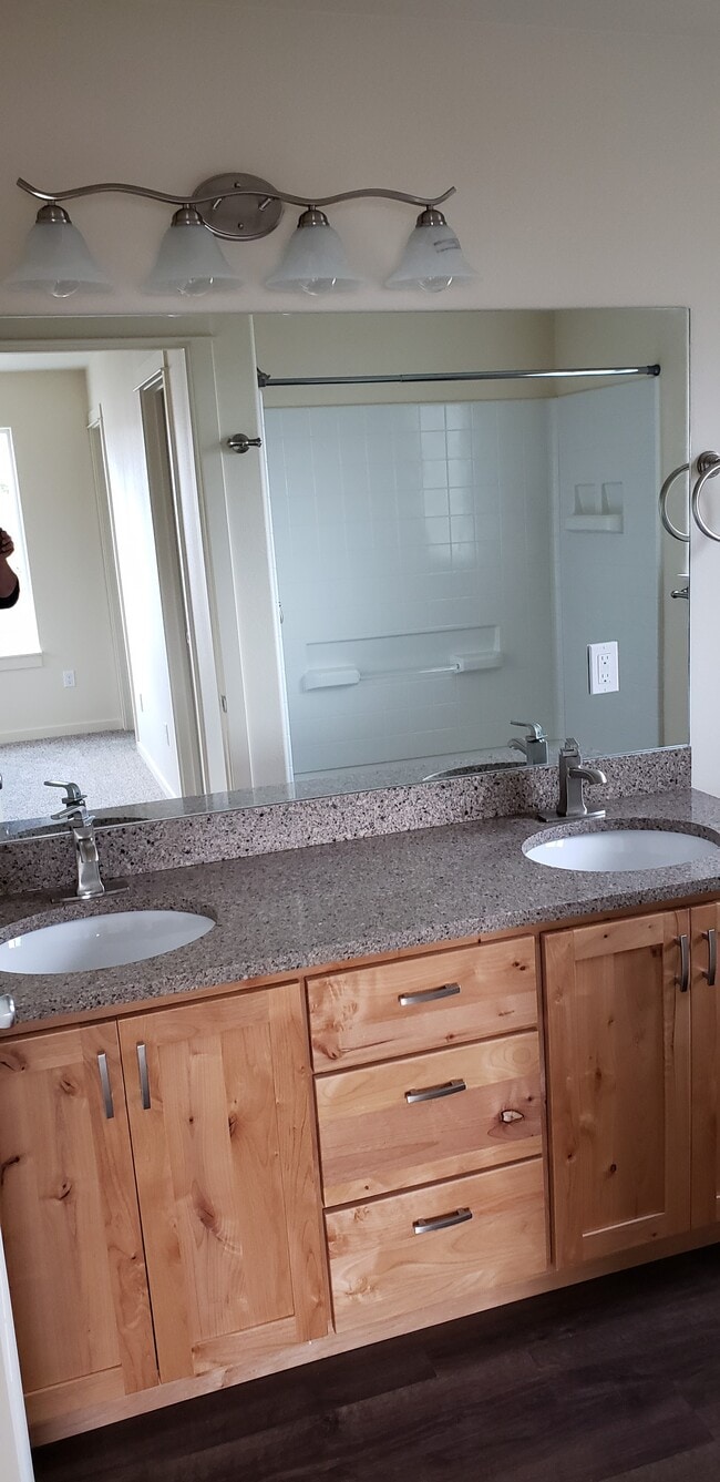 Master bath with granite countertops, linen closet, double sinks, and walk in shower w/ seat - 1121 Sundial Ln