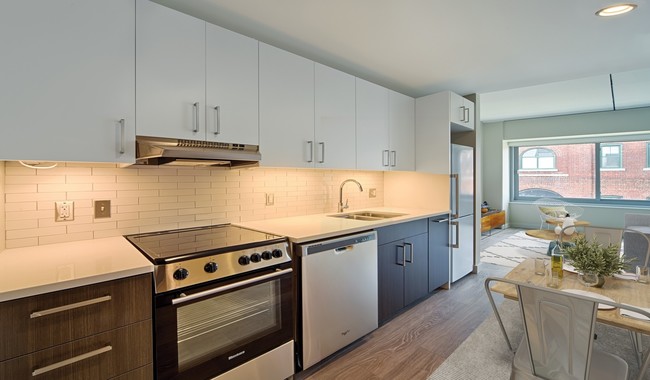 Open kitchens feature stainless steel appliances and quartz countertops - Vivo Apartments