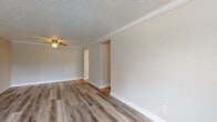 Located at 2909 Burroughs Dr in Pine Hills, FL, this single-story home offers a thoughtfully updated interior with a consistent, modern aesthetic throughout. Light-toned luxury vinyl plank flooring flows seamlessly across all living areas, complemented by crisp white baseboards and crown molding that add a clean, finished look to every room.

The spacious living area features a ceiling fan, textured ceiling, and neutral warm-gray walls, creating a bright and welcoming atmosphere. An adjacent room provides additional flexible living space, benefiting from a large window that invites natural light and views of the outdoors.

The kitchen is well-appointed with white shaker-style cabinetry, granite countertops, a double-basin sink with a gold-toned faucet, and a Whirlpool electric range, offering both style and functionality.

The bedrooms are generously sized, each featuring ceiling fans, textured ceilings, crown molding, and windows that allow natural light to fill the space. The full bathroom includes a white vanity with granite countertops, a tub-shower combination, and matching vinyl plank flooring.

A dedicated laundry room houses a full-size washer and dryer along with the water heater, providing practical utility space. The home's cohesive updates and neutral palette make it a move-in ready residence.