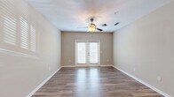Located at 915 Brentmoor Dr in Myrtle Beach, SC, this well-appointed single-floor residence offers a thoughtfully designed layout ideal for comfortable living. The heart of the home is an open-concept space that seamlessly combines the kitchen, dining, and living areas. The kitchen is a standout feature, showcasing dark espresso cabinetry reaching to the ceiling, granite countertops, a white subway tile backsplash, and a full suite of stainless steel appliances including a refrigerator, range, and microwave. A central kitchen island with a sink and pendant lighting above serves as both a functional workspace and a natural gathering point. The living area is bright and welcoming, finished with rich hardwood-style flooring, neutral warm-toned walls, a ceiling fan, and French doors that invite natural light and provide outdoor access. The bedroom is carpeted for comfort, features a ceiling fan, and is accompanied by a spacious walk-in closet with wire shelving on multiple walls. The full bathroom includes a granite-topped vanity with dark cabinetry, a tub/shower combo, and hardwood-style flooring. A dedicated in-unit laundry room with washer and dryer hookups, a pantry, and a utility room round out the practical amenities of this complete and efficiently organized home.