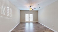 Located at 915 Brentmoor Dr in Myrtle Beach, SC, this well-appointed single-floor residence offers a thoughtfully designed layout ideal for comfortable living. The heart of the home is an open-concept space that seamlessly combines the kitchen, dining, and living areas. The kitchen is a standout feature, showcasing dark espresso cabinetry reaching to the ceiling, granite countertops, a white subway tile backsplash, and a full suite of stainless steel appliances including a refrigerator, range, and microwave. A central kitchen island with a sink and pendant lighting above serves as both a functional workspace and a natural gathering point. The living area is bright and welcoming, finished with rich hardwood-style flooring, neutral warm-toned walls, a ceiling fan, and French doors that invite natural light and provide outdoor access. The bedroom is carpeted for comfort, features a ceiling fan, and is accompanied by a spacious walk-in closet with wire shelving on multiple walls. The full bathroom includes a granite-topped vanity with dark cabinetry, a tub/shower combo, and hardwood-style flooring. A dedicated in-unit laundry room with washer and dryer hookups, a pantry, and a utility room round out the practical amenities of this complete and efficiently organized home.