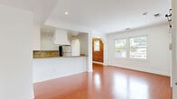 Located at 1236 N Flores St in the heart of West Hollywood, CA, this well-appointed unit blends classic character with modern updates throughout its efficiently designed single-floor layout. Rich hardwood flooring flows seamlessly across the open-concept living and dining areas, complemented by crisp white walls, crown molding, and recessed lighting. A standout feature is the dramatic exposed brick wall, which adds warmth and architectural interest to the living space. A stylish black-hardware barn door connects rooms while adding an industrial-chic touch. The kitchen is open to the main living area via a breakfast bar and features white shaker cabinetry, a bold diamond-pattern tile backsplash, granite countertops, a custom range hood, and stainless steel appliances. The bathroom offers classic charm with black-and-white mosaic penny tile flooring, a granite-topped vanity, gold-accented fixtures, and a window that brings in natural light. Multiple windows throughout the unit frame scenic views of the West Hollywood hills and cityscape, filling the space with abundant natural light. Two closets provide practical storage solutions, completing this character-rich unit in a prime Los Angeles location.