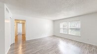 Located at 720 S Conway Rd in Orlando, FL, this single-story, 3-bedroom, 2-bathroom home offers a clean and functional layout designed for comfortable living. The open-concept living and dining area is bright and welcoming, featuring light-toned wood-style flooring, crisp white walls, and a textured ceiling. Natural light filters in through multiple windows fitted with blinds, creating an airy atmosphere throughout the main living space.

The kitchen is a standout feature, equipped with white shaker-style cabinetry, granite countertops, stainless steel appliances including a refrigerator, dishwasher, and range, as well as a pantry for additional storage. The wood-style tile flooring continues seamlessly through this space.

The three bedrooms are carpeted for comfort and each include ceiling fans with light fixtures. The generously sized primary bedroom offers its own closet with built-in shelving and hanging rods. A total of five closets throughout the home ensures ample storage. Both bathrooms are finished with granite-topped vanities and wood-style flooring, with one featuring a full tub and shower combination with clean white tile surround. Additional utility and hallway spaces complete the well-organized floor plan.