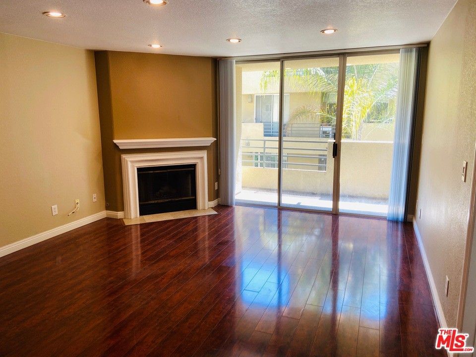 spacious living room with fireplace and patio - 6140 Monterey Rd