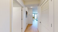 Located at 345 E Wacker Drive in the heart of Chicago, this well-appointed one-bedroom, one-bathroom residence offers an efficient and thoughtfully designed layout. Light hardwood flooring runs throughout the main living areas, creating a warm and cohesive aesthetic from the entry hallway to the open-concept living and kitchen spaces.

The kitchen is a functional standout, featuring rich wood cabinetry, stainless steel appliances including a gas range and full-size refrigerator, a white countertop island with bar seating, and pendant lighting — ideal for both everyday cooking and casual dining.

The living room is defined by dramatic floor-to-ceiling windows and a glass-paneled balcony door that floods the space with natural light and frames sweeping views of the Chicago skyline. This open area provides ample room for comfortable seating and everyday living.

The spacious bedroom continues the theme of abundant natural light, with large windows overlooking the city skyline. Plush carpeting, a dedicated closet, and direct access to the hallway make it a comfortable and practical retreat.

The bathroom features a clean, modern design with a wood-toned vanity, white countertop, and tiled flooring. A louvered closet door in the entry area adds additional storage convenience to complete this urban Chicago residence.