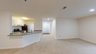 Located at 3350 Sweetwater Rd in Lawrenceville, GA, this 2-bedroom, 2-bathroom residence offers a thoughtfully designed single-level layout. The open-concept living and dining area is finished with plush carpeting and recessed lighting, creating a warm and inviting atmosphere. French doors lead to a private balcony, allowing natural light to fill the space.

The kitchen is well-equipped with stainless steel appliances, including an electric range and dishwasher, complemented by granite countertops, a classic white subway tile backsplash, and white shaker-style cabinetry. A breakfast bar peninsula connects the kitchen to the main living area, ideal for casual dining.

Both bedrooms are generously sized, carpeted, and feature windows with blinds that provide ample natural light. Each bathroom is outfitted with a tub-shower combination featuring white tile surround with a distinctive black tile accent border. One bathroom showcases warm hardwood-style flooring, while both offer granite-topped vanities with white cabinetry.

The unit's neutral color palette throughout creates a clean, move-in ready environment. The layout, as visible in the dollhouse view, maximizes the use of space efficiently, offering comfortable, functional living in Lawrenceville.