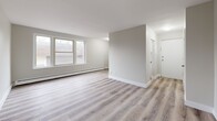This 480 square foot apartment, located at 383 Princess Ave in London, Ontario, offers a thoughtful layout maximizing space efficiency. The single-floor unit features one bedroom (120 sq ft) and one bathroom. The open concept design creates a seamless flow between the living areas, enhancing the sense of space.

The kitchen boasts modern white cabinetry, stainless steel appliances, and a subway tile backsplash. Light-toned wood-look flooring runs throughout, unifying the space and adding warmth. The bathroom showcases large-format tile in neutral tones, with a window providing natural light.

The living area benefits from large windows, flooding the space with daylight and offering views of the surroundings. Baseboard heating ensures comfort year-round. The bedroom, while compact, includes a window and closet space.

Clean lines, neutral colors, and contemporary finishes characterize the apartment's aesthetic, creating a bright and inviting atmosphere. Despite its modest size, the thoughtful design of this urban dwelling provides all the essentials for comfortable city living.