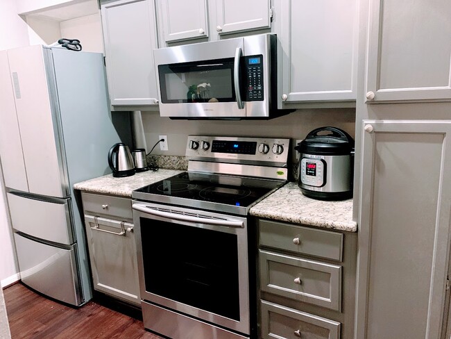 All new granite counter tops and stainless steel appliances. Two-door fridge with plenty of spaces. - 2121 El Paseo St