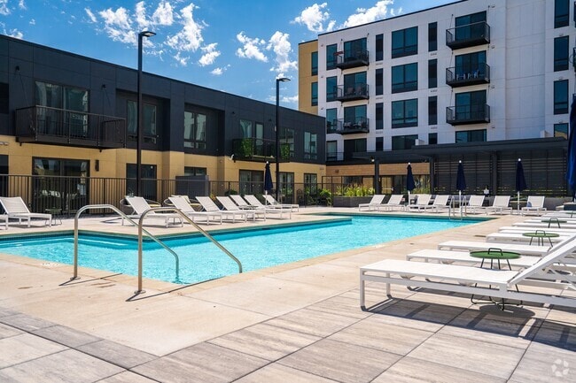 Dive into resort-style living with a sparkling pool and plenty of lounge seating. - Aspire at CityPlace