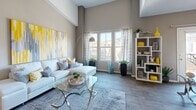 Located at 9465 W Post Rd in Las Vegas, NV, this two-story, 2-bedroom, 2-bathroom home offers a well-designed layout spread across two levels. Entry is via a carpeted staircase that leads up to the main living level, where an open-concept space seamlessly integrates the living room, dining area, and kitchen. The living room impresses with soaring ceilings, warm neutral tones, and wood-style flooring, while large windows invite abundant natural light. The dining area features a stylish chandelier and an accent wall, adding a touch of sophistication. The galley-style kitchen is equipped with warm wood cabinetry, granite-style countertops, a gas range, and ample storage. Both bedrooms are carpeted and well-proportioned, offering natural light through large windows. The primary bedroom includes a walk-in closet with built-in shelving. The two bathrooms are finished with wood-style flooring, granite-topped vanities, and glass-enclosed showers. Additional highlights include two closets, a dedicated laundry area, and a private balcony. The home's cohesive neutral palette and thoughtful layout make it a comfortable and functional residence.