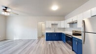 Located at 5339 US-319 S in Thomasville, Georgia, this well-appointed single-story residence offers two bedrooms, two bathrooms, and a thoughtfully designed layout. Light hardwood-style flooring flows consistently throughout the home, creating a clean and cohesive aesthetic.

The kitchen is a standout feature, showcasing bold two-tone cabinetry with navy blue lower cabinets and crisp white upper cabinets, complemented by light countertops and stainless steel appliances including a range and refrigerator. An under-cabinet range hood and a single-basin sink complete this functional and visually striking space.

An arched passageway connects the kitchen to the open living area, which is outfitted with a ceiling fan and receives generous natural light through window blinds. The bright, neutral walls contribute to an airy and welcoming ambiance throughout.

The primary bedroom offers a comfortable footprint with ample closet storage. The bathrooms are finished with navy vanity cabinetry, LED-backlit mirrors, white countertops, and tub-shower combinations with clean tile surrounds. Three closets across the unit provide excellent storage capacity.

Hallways connect the rooms efficiently, and the overall layout maximizes the use of space. The home presents a modern, move-in-ready interior with contemporary finishes throughout.