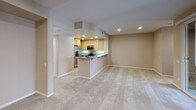 Located at 5226 Zephyr Ln in San Diego, California, this single-floor residence offers a well-designed, open-concept layout that maximizes both functionality and comfort. The living area is generously proportioned, finished with plush neutral carpeting and recessed lighting, and flows seamlessly into the kitchen via a peninsula-style breakfast bar with granite countertops — ideal for casual dining or entertaining. The kitchen is equipped with stainless steel appliances, including a gas range, over-the-range microwave, and refrigerator, all complemented by warm maple cabinetry and granite tile countertops with under-cabinet lighting. Bedroom spaces are carpeted and well-lit, with ceiling fans providing year-round comfort. One bedroom features a large sliding glass door with vertical blinds, allowing ample natural light. The primary bathroom offers a dual-sink vanity with granite countertops, warm wood cabinetry, and a shower-tub combination. A second full bathroom mirrors this clean aesthetic with tile flooring, a tub-shower unit, and chrome fixtures. Throughout, the space maintains a cohesive, neutral warm-beige palette, recessed lighting, and clean white trim, creating a bright and inviting atmosphere well-suited to the sunny San Diego climate.