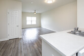 Located on N Country Club Drive in Montgomery, Alabama, this single-floor unit offers a thoughtfully designed open-concept layout that promotes a sense of spaciousness and ease of flow. The living area features warm wood-style flooring and a ceiling fan, creating a comfortable and inviting atmosphere, with a window dressed in blinds that allows for controlled natural light.

The kitchen is a functional centerpiece of the home, equipped with rich dark cabinetry, light countertops, a double-basin stainless steel sink, and a full suite of white appliances including a refrigerator, electric range, built-in microwave, and dishwasher. The kitchen opens directly to the living area, making it ideal for everyday living and entertaining.

The hallway connects the main living spaces to the private areas of the unit, where multiple doors lead to well-sized rooms. Each bedroom features the same wood-style flooring, neutral walls, and windows that bring in natural light while maintaining privacy. The bathroom is finished with tile flooring, a wide vanity featuring dark cabinetry and a white countertop, a large mirror, and a shower-tub combination. Grab bars are also present, adding a practical touch. Throughout the unit, clean white trim and neutral tones create a cohesive and move-in-ready aesthetic.