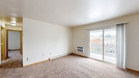 Located at 1610 Schaefer Cir in Appleton, Wisconsin, this single-floor, 2-bedroom, 1-bathroom residence offers a practical and comfortable layout. The living room is a bright, open space featuring plush carpeting, a baseboard heating system, and a sliding glass door that opens to a private balcony, allowing natural light to fill the room and providing views of the surrounding neighborhood. The kitchen is efficiently designed with white cabinetry, white appliances including a range and refrigerator, a stainless steel sink, and durable tile flooring, making it a functional space for everyday use. Both bedrooms are carpeted and feature neutral walls, baseboard heaters, and windows that bring in natural light. The primary bedroom is generously sized and includes a dedicated closet with built-in hanging rods and shelving, offering ample storage. The second bedroom also features a closet for additional storage convenience. The full bathroom is clean and straightforward, equipped with a full-size soaking tub and shower combination. Throughout the residence, warm wood-toned trim and baseboards add a cohesive, classic finish to the bright, neutral interior palette.