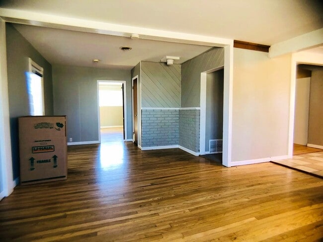Entertain in the living area highlighted with new paint & hardwood floors! - 7590 Bradburn Blvd