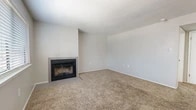 Located at 4201 Meadowlark Ln SE in Rio Rancho, New Mexico, this single-story, one-bedroom, one-bathroom residence offers a practical and comfortable layout. The open living room serves as the heart of the home, featuring warm neutral carpet, a textured ceiling, and a tile-surround wood-burning fireplace as a central focal point. A large window with blinds allows natural light to fill the space, creating a bright and inviting atmosphere.

The galley-style kitchen is efficiently designed with white cabinetry, light countertops, wood-look vinyl flooring, and stainless steel appliances including a full-size refrigerator. A window above the sink brings in additional natural light, enhancing the clean, functional workspace.

The bedroom offers a comfortable retreat with plush carpet, a ceiling fan with light fixture, and a window with natural light. A dedicated closet provides ample storage.

The bathroom is finished with wood-look vinyl flooring, white cabinetry with brushed nickel hardware, and a full tub-shower combination. A hallway connects the rooms, contributing to an efficient and logical flow throughout the space. Neutral tones and consistent finishes throughout lend the home a cohesive, move-in-ready character.