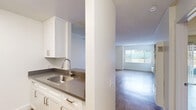 Located at 125 W Olive Ave in Monrovia, California, this single-floor, one-bedroom, one-bathroom unit offers a thoughtfully organized layout with a clean, neutral aesthetic throughout. Light wood-style flooring runs continuously across the living areas and bedroom, creating a cohesive and inviting feel.

The main living area is bright and open, featuring a textured ceiling, a ceiling fan, and a large window that admits generous natural light while offering outdoor views. A wall-mounted HVAC unit provides climate control. The space flows naturally toward a pass-through kitchen, which is defined by a raised counter bar, white cabinetry, dark countertops, and stainless steel appliances including a refrigerator and microwave — ideal for both everyday cooking and casual dining.

The bedroom is spacious and serene, with its own ceiling light fixture and direct access to additional areas of the unit, including a dedicated closet for storage.

The bathroom is clean and well-finished, featuring a full tub and shower combination with a curved curtain rod, a white vanity with dark countertop, brushed nickel hardware, a framed mirror, and wood-style tile flooring that ties the room together with the rest of the unit.

Overall, this unit presents a bright, functional, and comfortable living space in the heart of Monrovia.