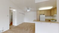 This single-story residence at 300 Hilary Way in Vallejo, California offers a bright, functional layout with a clean, neutral palette throughout. The open-concept living and dining area features warm carpeting underfoot and vaulted ceilings accented by a ceiling fan, creating an airy and comfortable atmosphere. A sliding glass door floods the living space with natural light and provides access to a private balcony with outdoor views, while an additional large window further enhances the sense of openness.

The kitchen is thoughtfully designed with light wood flooring, ample cabinetry finished in a warm beige tone, and white appliances including a refrigerator, electric range, and dishwasher. A peninsula counter separates the kitchen from the living area, offering a convenient space for casual dining or food preparation.

The bedroom is generously sized, carpeted, and features a large window that brings in natural light and outdoor views. It is complemented by a well-organized walk-in closet with built-in shelving, providing excellent storage. The full bathroom is finished with wood-look flooring, a combined tub and shower, and a vanity with a light-toned countertop. The overall design of this residence is practical and welcoming, making it an ideal space in the heart of Vallejo.