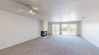 Located at 1175 Lake Blvd in Davis, CA, this well-designed 2-bedroom, 4-bathroom residence offers a comfortable and functional single-floor layout. The spacious living room is a standout, featuring plush carpeting, a ceiling fan, a tile-surround fireplace, and sliding glass doors that open to a private balcony, inviting abundant natural light and outdoor views. An elegant arched entryway connects the main living area to the rest of the home, adding a subtle architectural touch. The kitchen is equipped with white cabinetry, dark countertops, and stainless steel appliances including a gas range and built-in microwave, all set over light wood-look flooring. Both bedrooms are generously sized with soft carpeting and ample natural light. The spacious primary bedroom includes access to a well-appointed bathroom with white vanity cabinetry and a walk-in closet with built-in shelving. Additional bathrooms feature wood-look flooring and glass-enclosed showers. A dedicated laundry room with side-by-side washer and dryer adds everyday convenience. Two closets throughout the home provide excellent storage. The overall ambiance is bright, clean, and move-in ready.