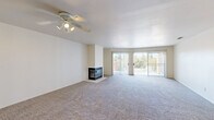 Located at 1175 Lake Blvd in Davis, CA, this well-designed 2-bedroom, 4-bathroom residence offers a comfortable and functional single-floor layout. The spacious living room is a standout, featuring plush carpeting, a ceiling fan, a tile-surround fireplace, and sliding glass doors that open to a private balcony, inviting abundant natural light and outdoor views. An elegant arched entryway connects the main living area to the rest of the home, adding a subtle architectural touch. The kitchen is equipped with white cabinetry, dark countertops, and stainless steel appliances including a gas range and built-in microwave, all set over light wood-look flooring. Both bedrooms are generously sized with soft carpeting and ample natural light. The spacious primary bedroom includes access to a well-appointed bathroom with white vanity cabinetry and a walk-in closet with built-in shelving. Additional bathrooms feature wood-look flooring and glass-enclosed showers. A dedicated laundry room with side-by-side washer and dryer adds everyday convenience. Two closets throughout the home provide excellent storage. The overall ambiance is bright, clean, and move-in ready.