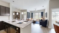 Located at 1824 Defoor Ave NW in Atlanta's vibrant West Midtown neighborhood, this thoughtfully designed 3-bedroom, 2-bathroom home offers a comfortable and modern single-floor layout. The open-concept living room is bathed in natural light from large windows dressed with stylish drapes, and features light hardwood-style flooring and a ceiling fan for year-round comfort. The kitchen is well-equipped with dark espresso cabinetry, granite countertops, a classic white subway tile backsplash, and a full suite of stainless steel GE appliances, including a range, over-the-range microwave, and refrigerator. The primary bedroom is a serene retreat with plush carpet flooring and generous closet space. The en-suite primary bathroom offers a dual-sink vanity with granite countertops, dark cabinetry, and a glass-enclosed shower. The two additional bedrooms share a second full bathroom, which also features a glass-enclosed shower and granite vanity. Soft carpet runs throughout the bedroom hallway, lending a warm, quiet feel to the private areas of the home. Two dedicated closets provide ample storage. Neutral tones and clean lines create a cohesive, move-in-ready aesthetic throughout the entire space.